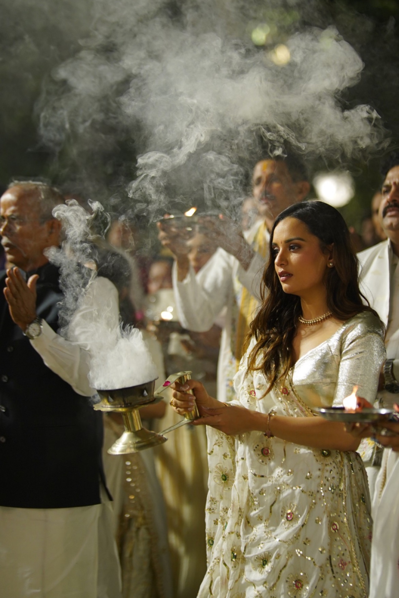 Aarti with incense smoke under moonlight