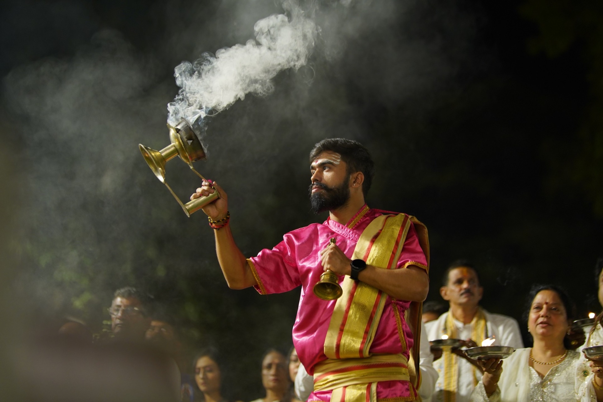 Priest performing aarti with sacred smoke